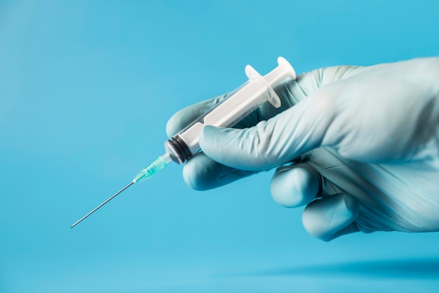 Doctor holding a syringe close-up