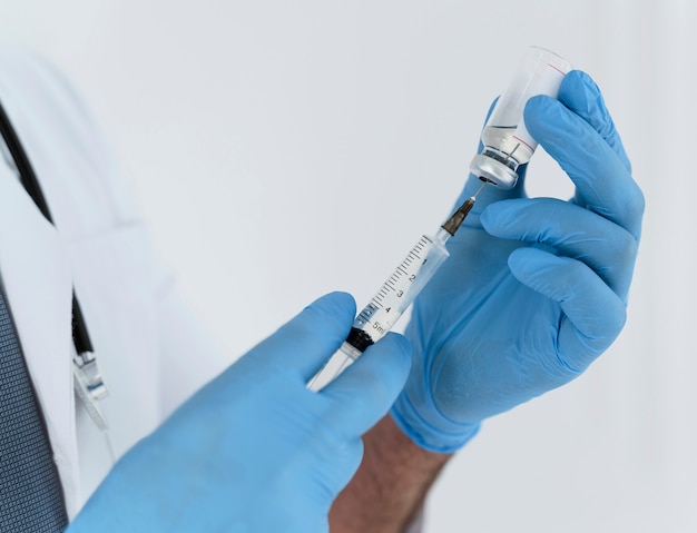 Doctor holding a syringe close-up