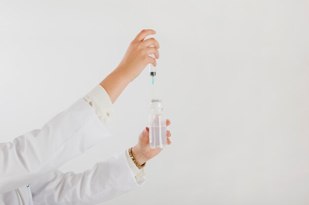 Doctor holding syringe and test tube