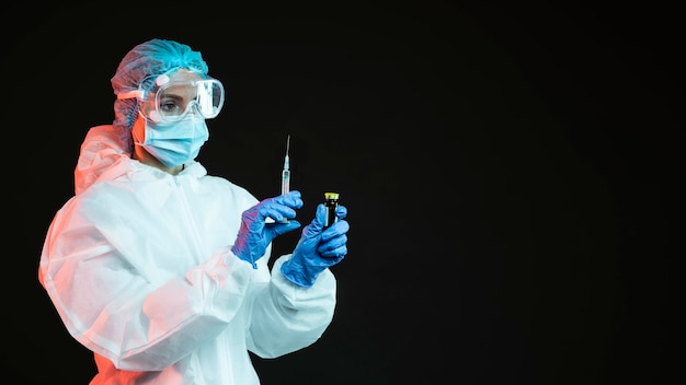Doctor holding a syringe with copy space