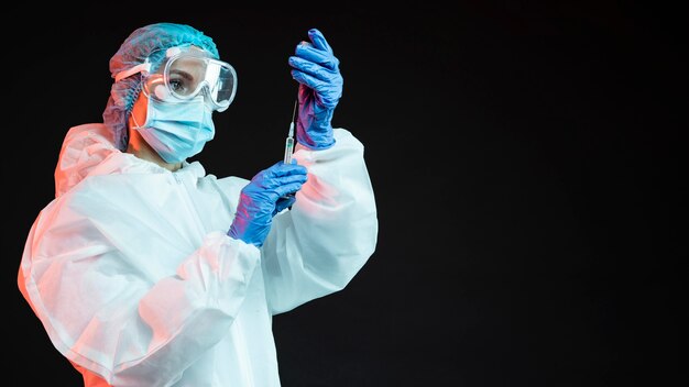 Doctor holding a syringe with copy space