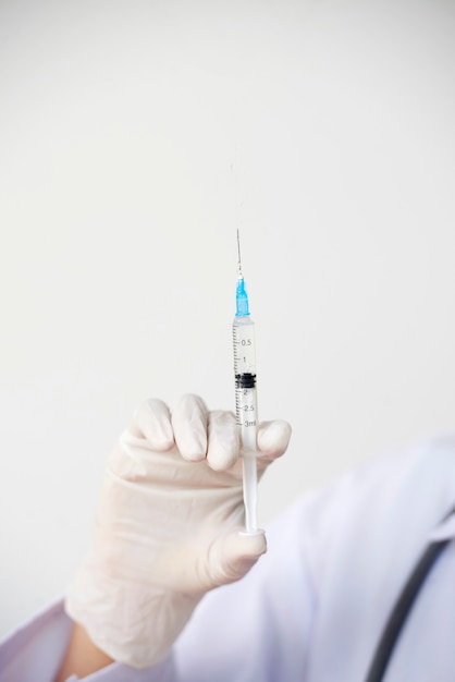 Doctor holding syringe with vaccine