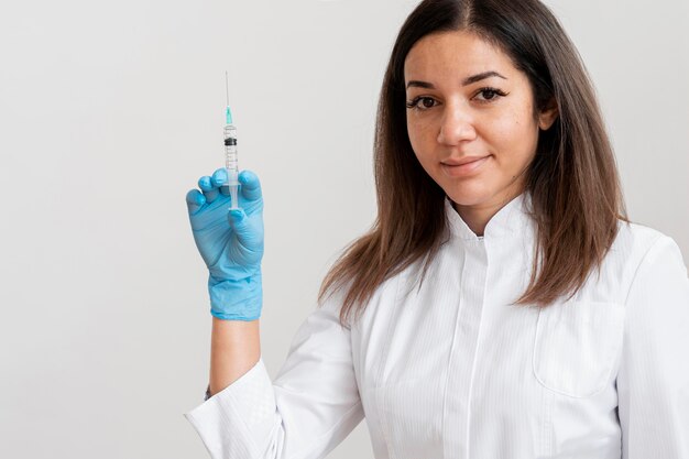 Doctor holding syringe with vaccine