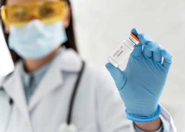 Doctor holding a vaccine recipient in her hand