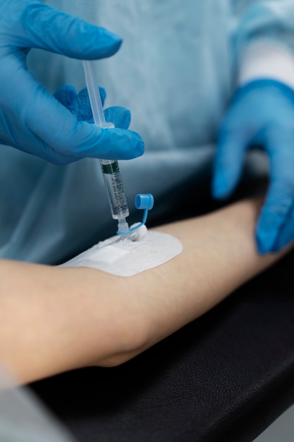 Doctor injecting the anesthesia on patient's arm