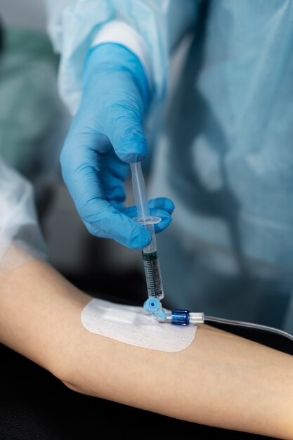 Doctor injecting the anesthesia on patient's arm