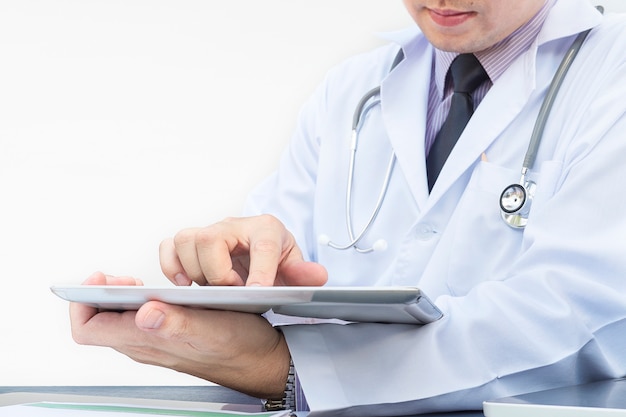 Doctor is working with tablet over white background