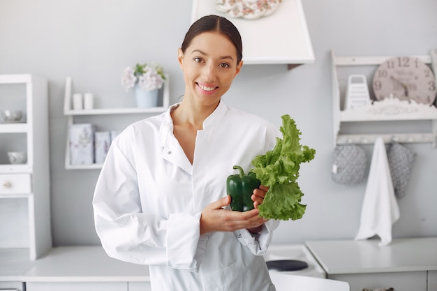 Doctor in a kitchen with vegetables