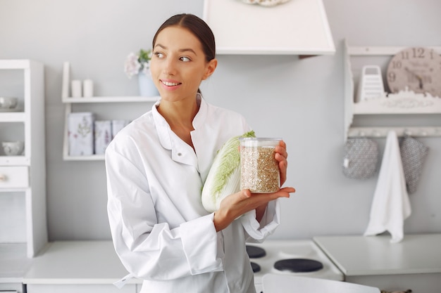 Doctor in a kitchen with vegetables