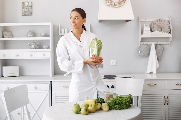 Doctor in a kitchen with vegetables