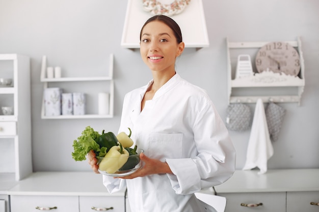 Doctor in a kitchen with vegetables