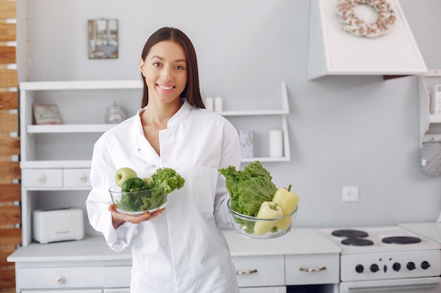 Doctor in a kitchen with vegetables