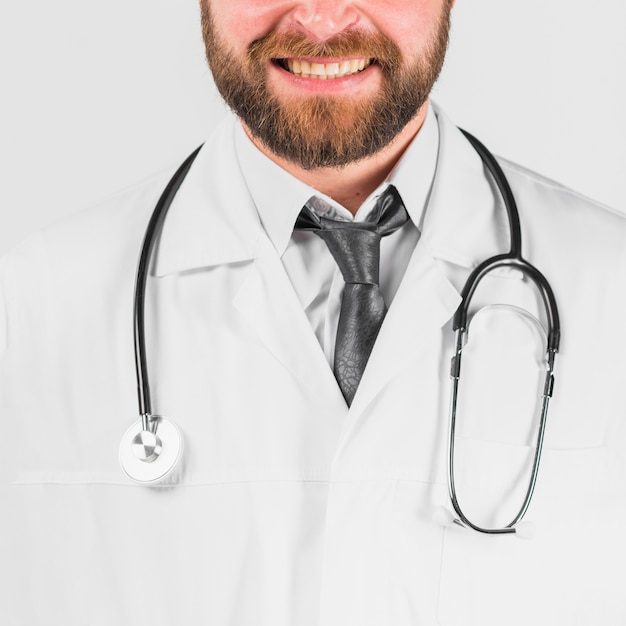 Doctor in lab coat and stethoscope smiling