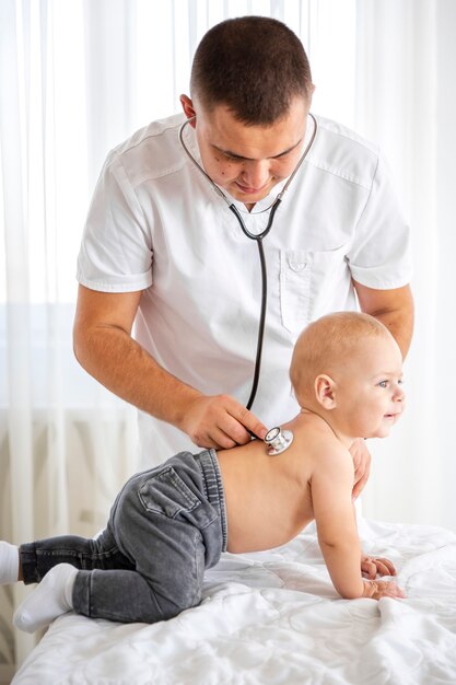 Doctor listening cute little baby with stethoscope