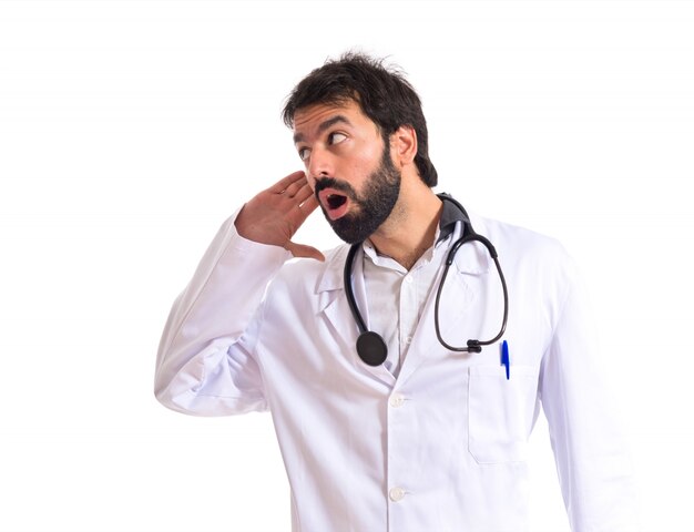 Doctor listening over isolated white background