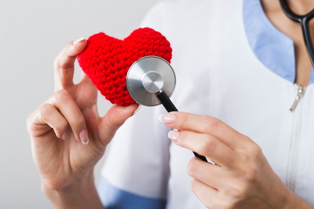 Doctor listening to a plush heart