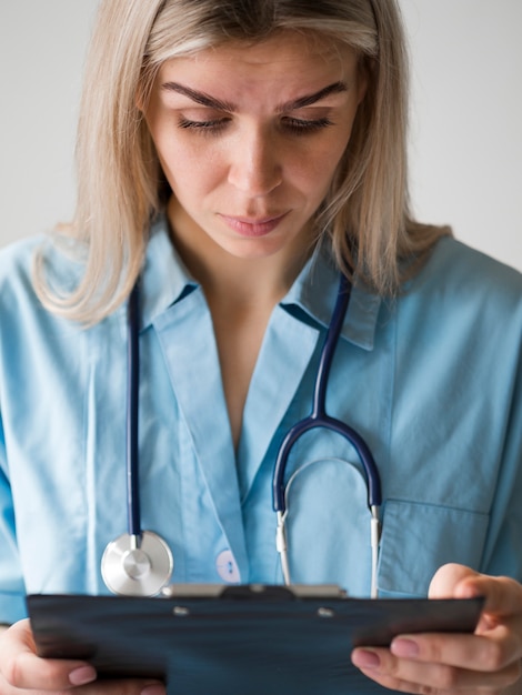 Doctor looking at clipboard