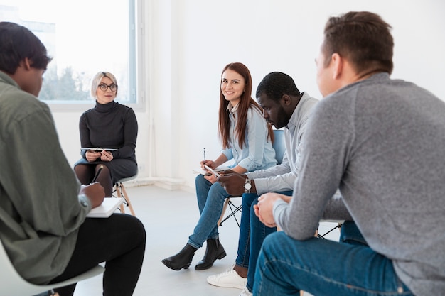 Free photo doctor looking at patients talking to each other