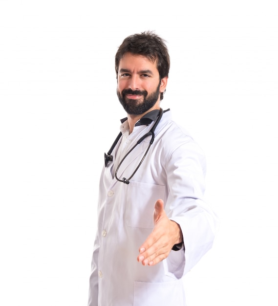 Doctor making a deal over isolated white background