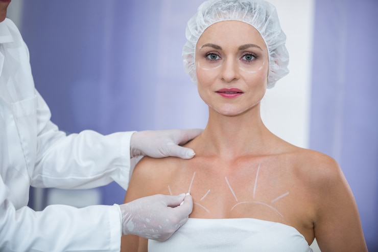 Free Photo doctor marking female patients body for breast surgery