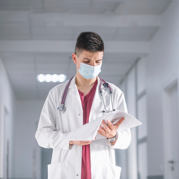 Doctor in mask with papers