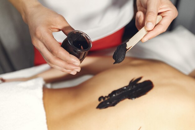 The doctor massages the woman with a chocolate