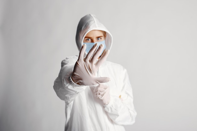 Doctor in a medical mask. Coronavirus theme. Isolated over white wall