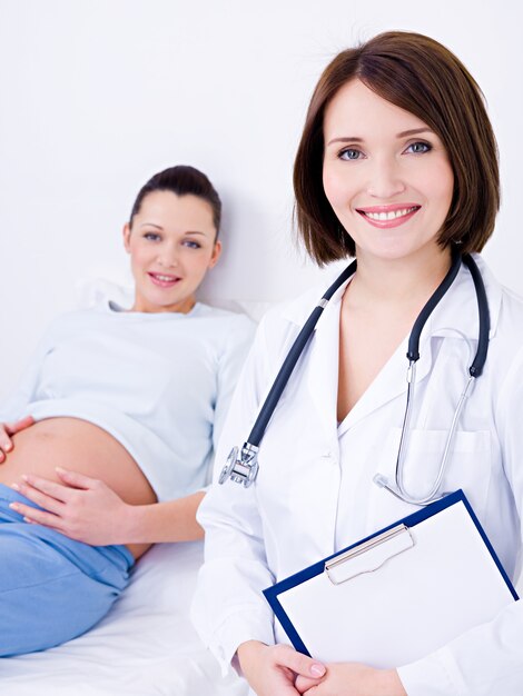 Doctor near the pregnant woman at hospital