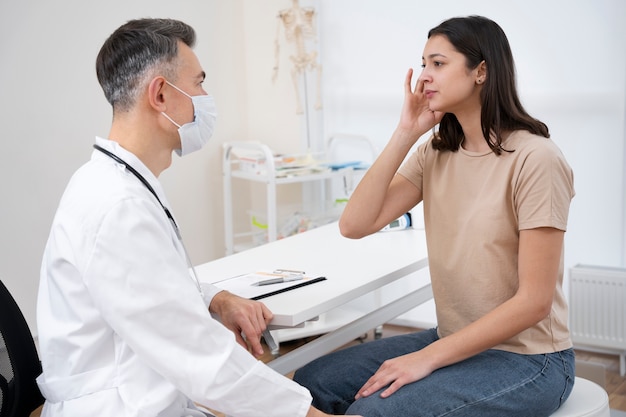 Free photo doctor performing routine medical checkup