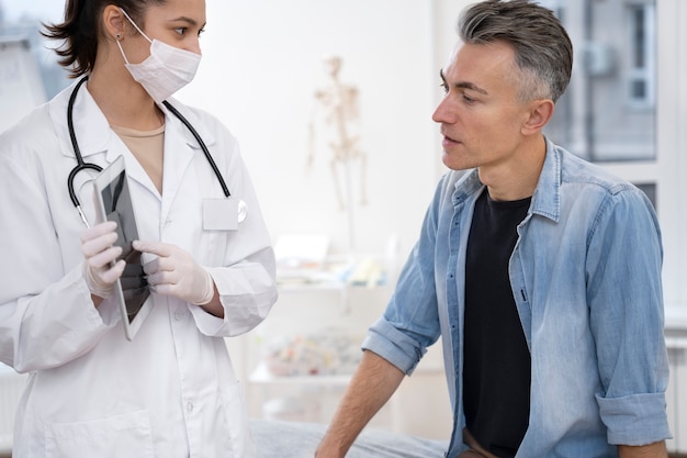 Free photo doctor performing routine medical checkup