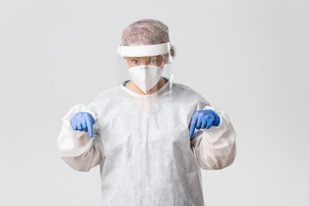 Doctor in personal protective equipment posing