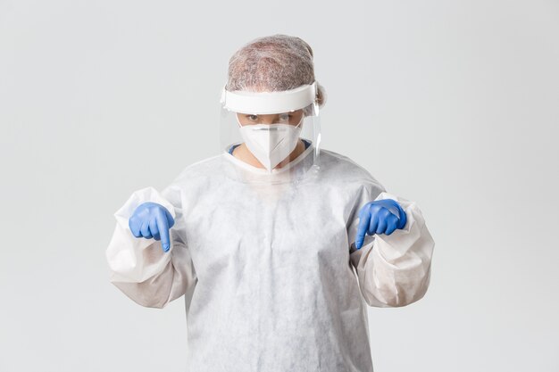 Doctor in personal protective equipment posing