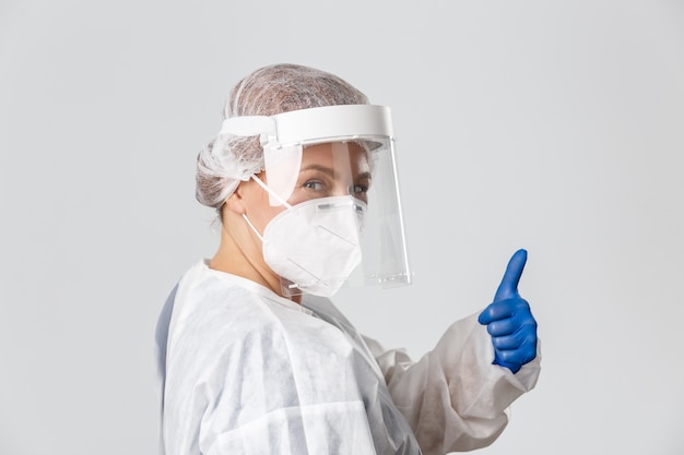 Free photo doctor in personal protective equipment posing