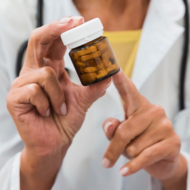 Doctor pointing to a bottle of pills