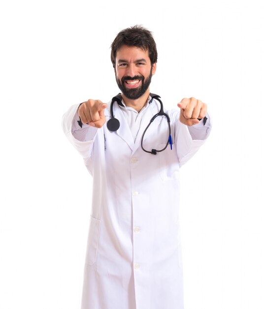 Doctor pointing to the front over white background