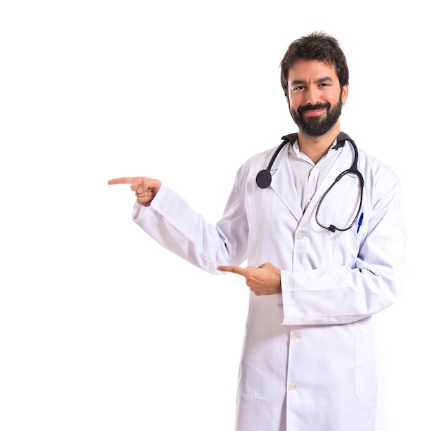 Doctor pointing to the lateral over white background
