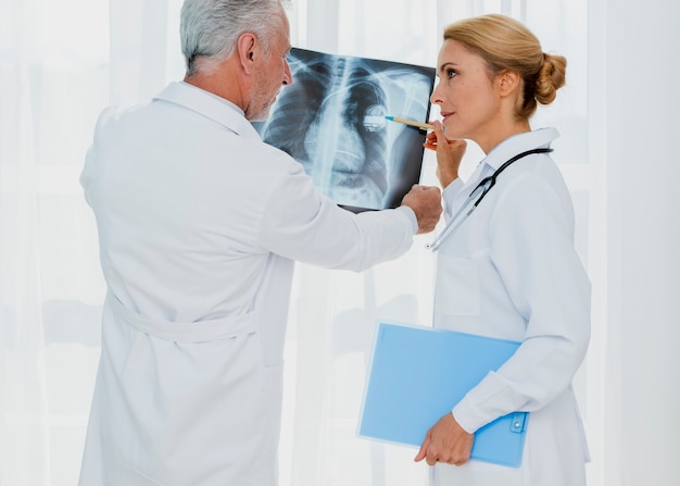 Doctor pointing at pacemaker on x-ray