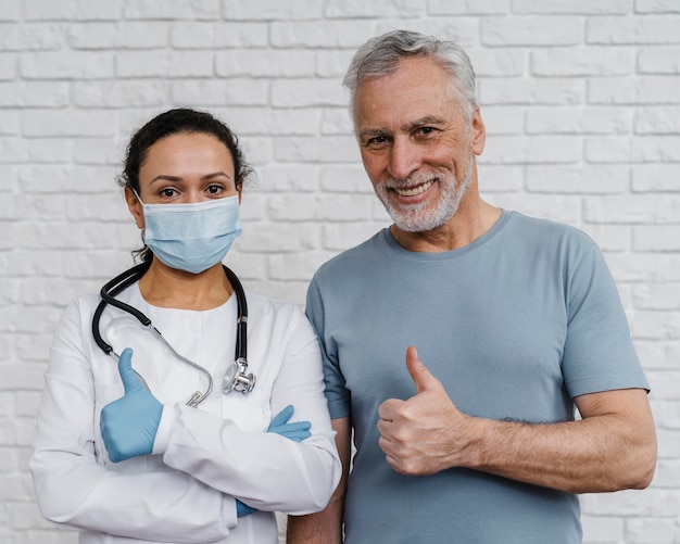 Free photo doctor posing with her patient