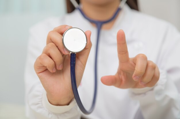 Doctor practicing with her stethoscope