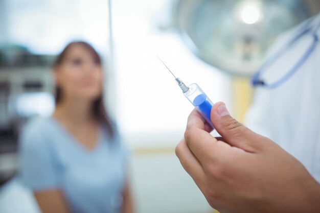 Doctor preparing a syringe to give an injection