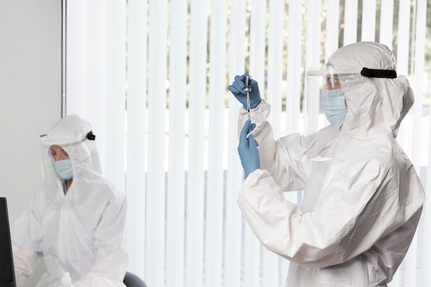 Doctor preparing the vaccine for a patient