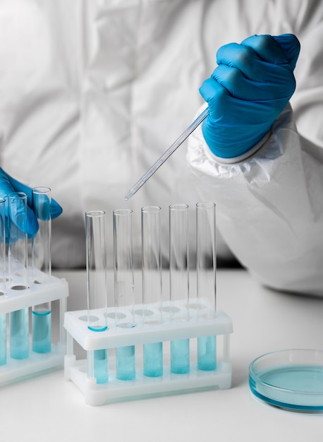 Doctor in protective suit making tests in lab