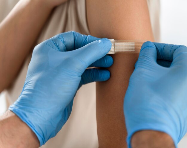 Doctor putting a bandage on a patient's arm