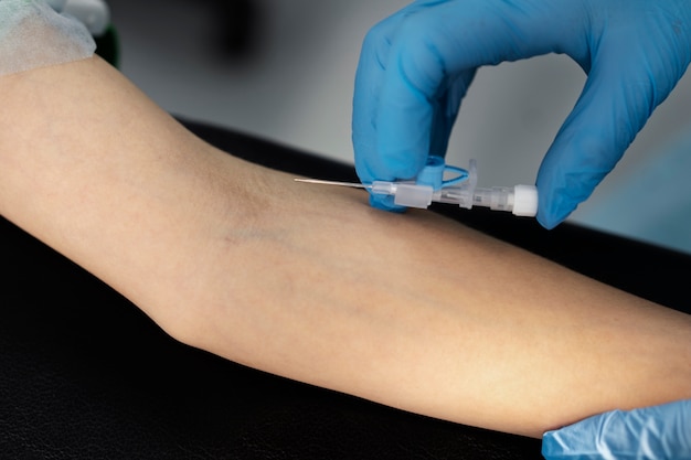 Doctor putting an iv on patient's arm