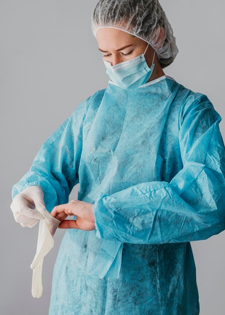 Doctor putting on surgical gloves