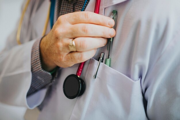 Doctor reaching for his pen