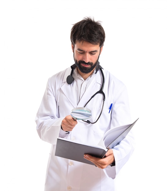 Doctor reading a book over white background