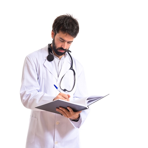 Doctor reading a book over white background