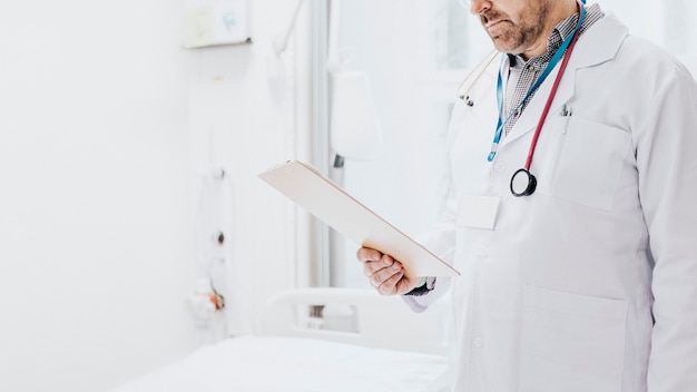 Doctor reading a coronavirus patient medical chart