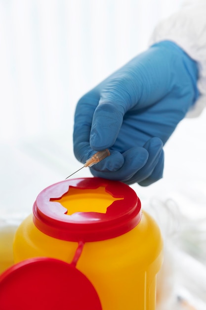 Doctor recycling an used syringe